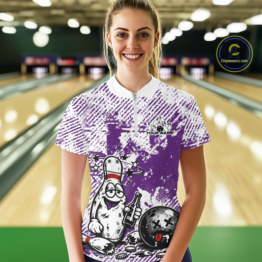 Female model wearing purple and white bowling quarter zip in bowling lane, humorous drunk bowling pin graphic with beer bottle, sporty promotional lighting