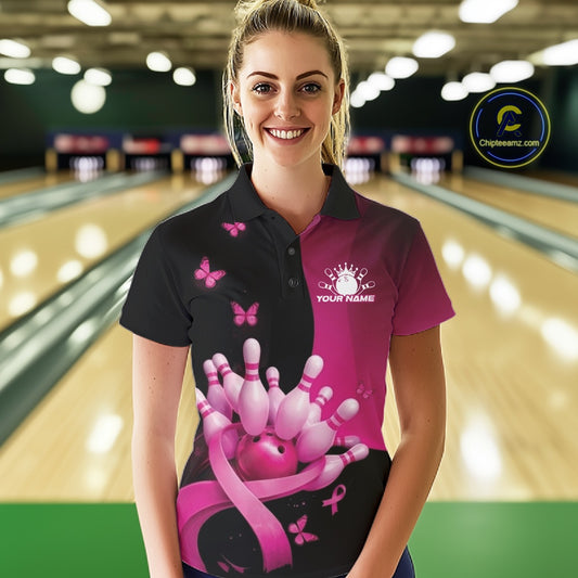 Female model in a bowling lane wearing a black and pink polo shirt with breast cancer awareness ribbons, butterflies, and bowling-themed artwork.