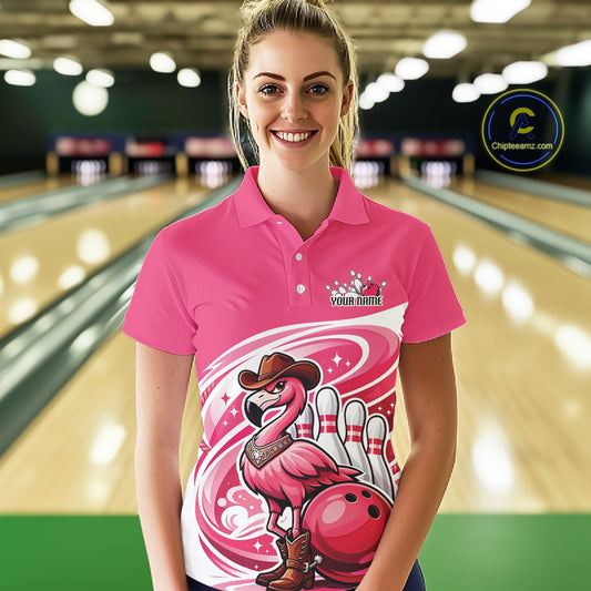 Female model at a bowling lane wearing a pink bowling polo shirt with a cowboy flamingo and bowling ball design.