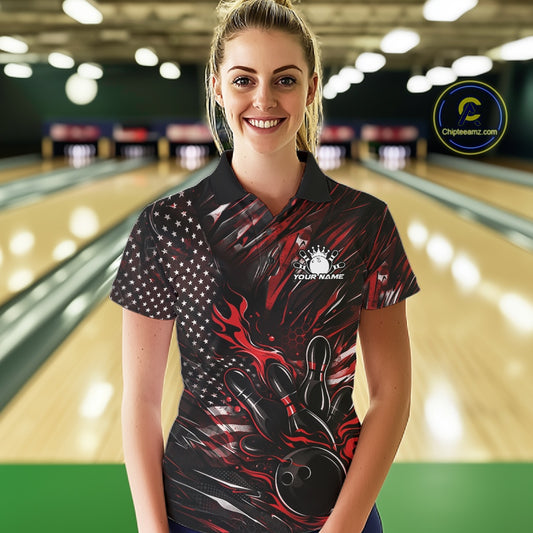 Female model wearing a black and red bowling polo shirt at a bowling lane with fiery bowling strike artwork and patriotic accents.