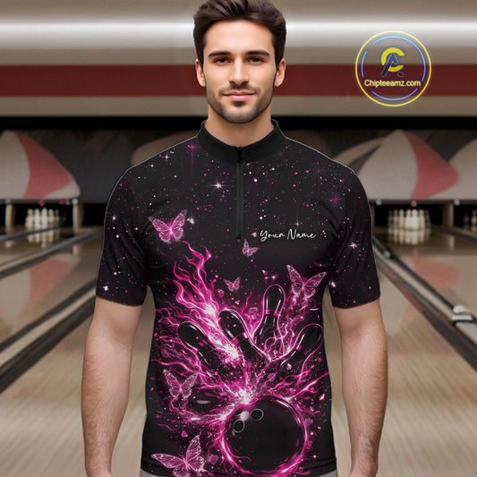 Male model wearing a black and pink bowling quarter-zip shirt at the lane with cosmic flaming strike artwork.