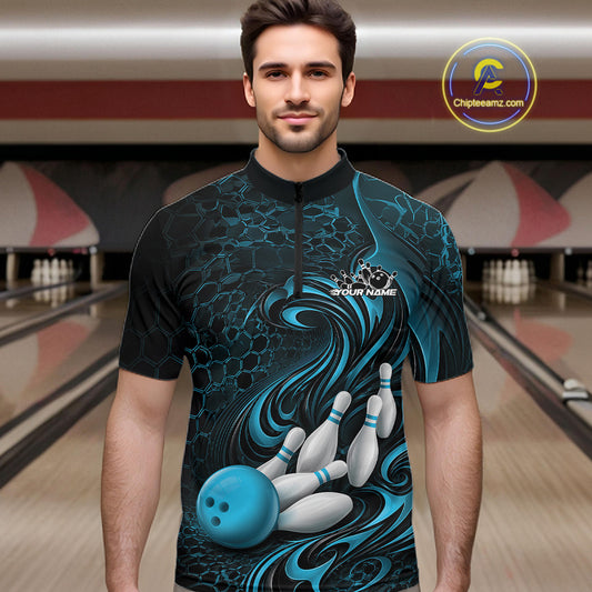 Male model wearing a black and blue bowling quarter-zip shirt in a bowling alley featuring a tribal flame bowling ball and pins graphic