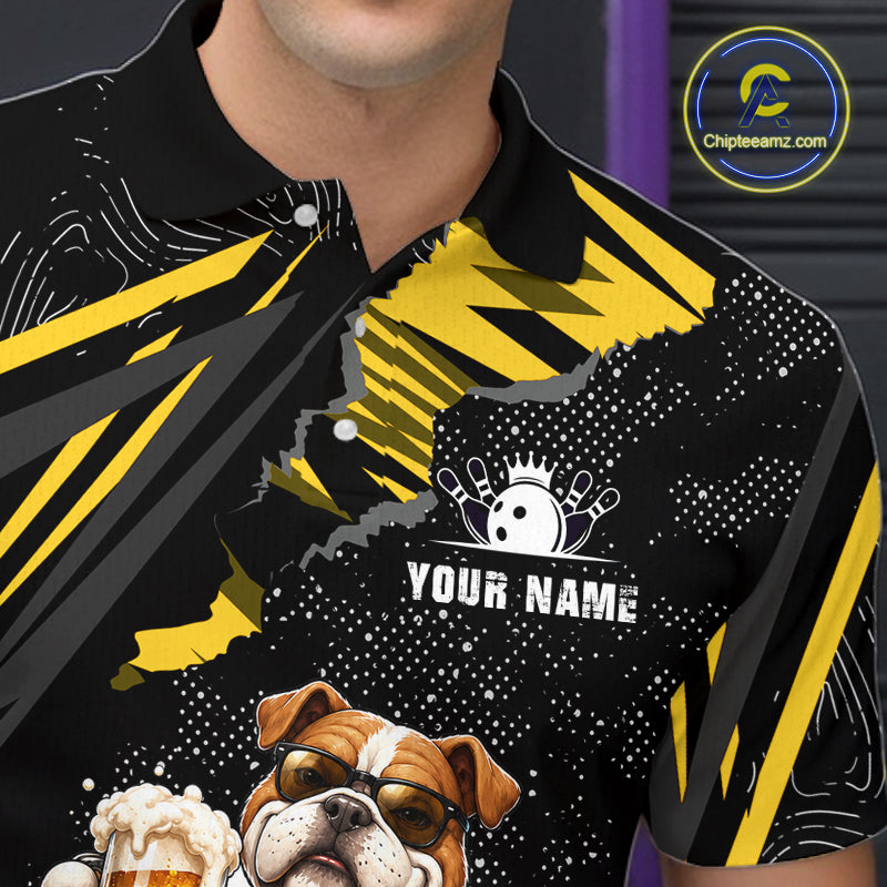A close-up of a man wearing a black short-sleeve polo shirt with a bold yellow graphic design, featuring a bulldog illustration, white speckled patterns, and a customizable 'YOUR NAME' print on the chest.