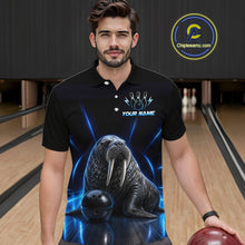 Load image into Gallery viewer, Man wearing a black polo shirt with a walrus and bowling ball design in a bowling alley.