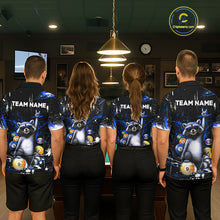 Load image into Gallery viewer, Four people wearing matching bowling-themed shirts with raccoon graphics in a bowling alley.