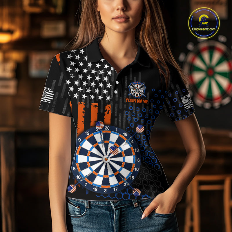 Female model wearing a custom black darts polo shirt featuring an American flag star pattern, a large dartboard graphic, and customizable 'YOUR NAME' text on the chest