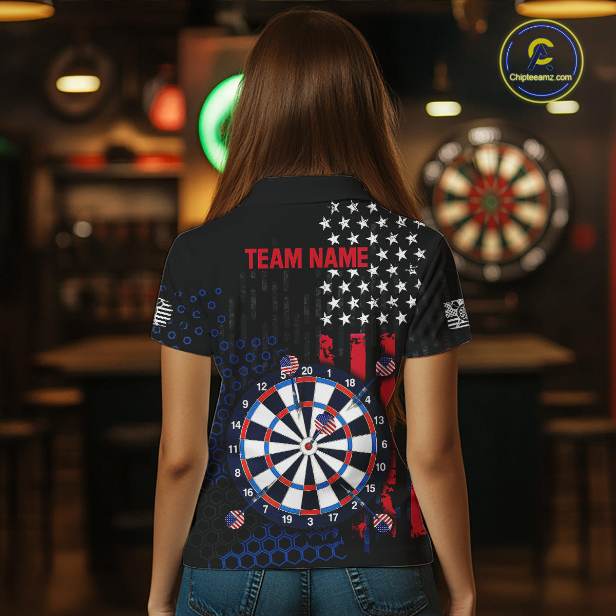Back view of a female model wearing a custom black darts polo shirt featuring an American flag design, a large dartboard graphic, and 'TEAM NAME' printed in red