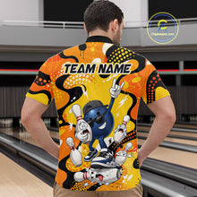 Load image into Gallery viewer, Person wearing a colorful bowling-themed shirt with cartoon characters in a bowling alley.