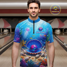 Load image into Gallery viewer, Man wearing a colorful bowling shirt with an underwater design in a bowling alley.