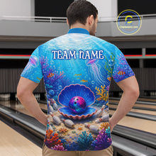 Load image into Gallery viewer, Man wearing a colorful bowling shirt with an underwater scene design in a bowling alley.