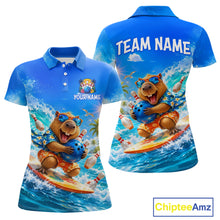 Load image into Gallery viewer, Blue polo shirt with a bear surfing design on a white background, featuring 'Chiptee Amz' branding.