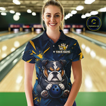 Load image into Gallery viewer, Female model wearing a custom blue bulldog bowling polo shirt front view featuring a fierce cartoon bulldog, bowling ball, gold lightning accents and navy blue abstract pattern at the bowling alley