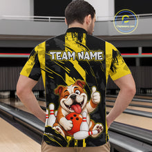 Load image into Gallery viewer, Male model wearing a custom black yellow bulldog bowling quarter-zip shirt back view displaying the personalized team name above a playful cartoon bulldog graphic at the bowling alley