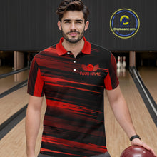 Load image into Gallery viewer, Male model wearing a custom black red bowling polo shirt front view featuring a red bowling ball emblem, dynamic red brush stroke pattern and striped design at the bowling alley