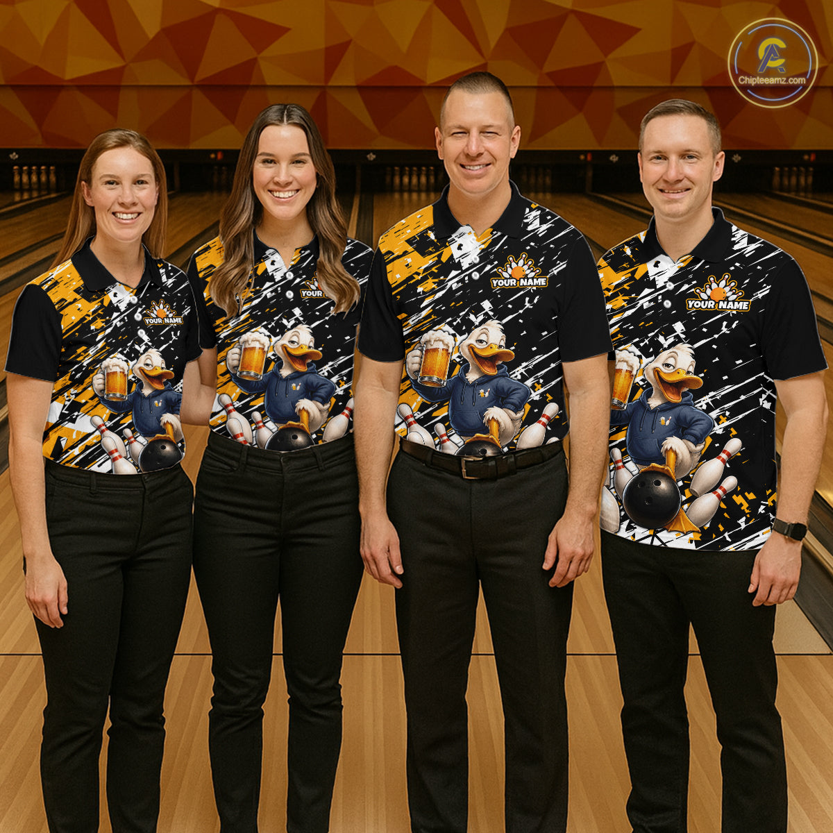 Four people standing together in a bowling alley wearing matching black short-sleeve bowling shirts with a colorful cartoon duck graphic and black pants. 
