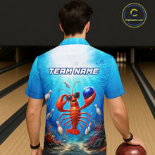 Load image into Gallery viewer, Person wearing a blue bowling shirt with a lobster design and 'TEAM NAME' text in a bowling alley.