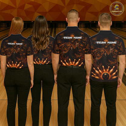 Four people standing with their backs to the camera in a bowling alley, wearing matching dark navy bowling shirts with a fiery orange and gold bowling pin graphic on the back and white 'TEAM NAME' text. 