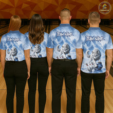 Load image into Gallery viewer, Four people wearing matching blue shirts with wolf graphics and 'Team Name' text on a bowling alley background.