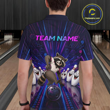 Load image into Gallery viewer, Person wearing a bowling-themed shirt with a raccoon and bowling pins design in a bowling alley.