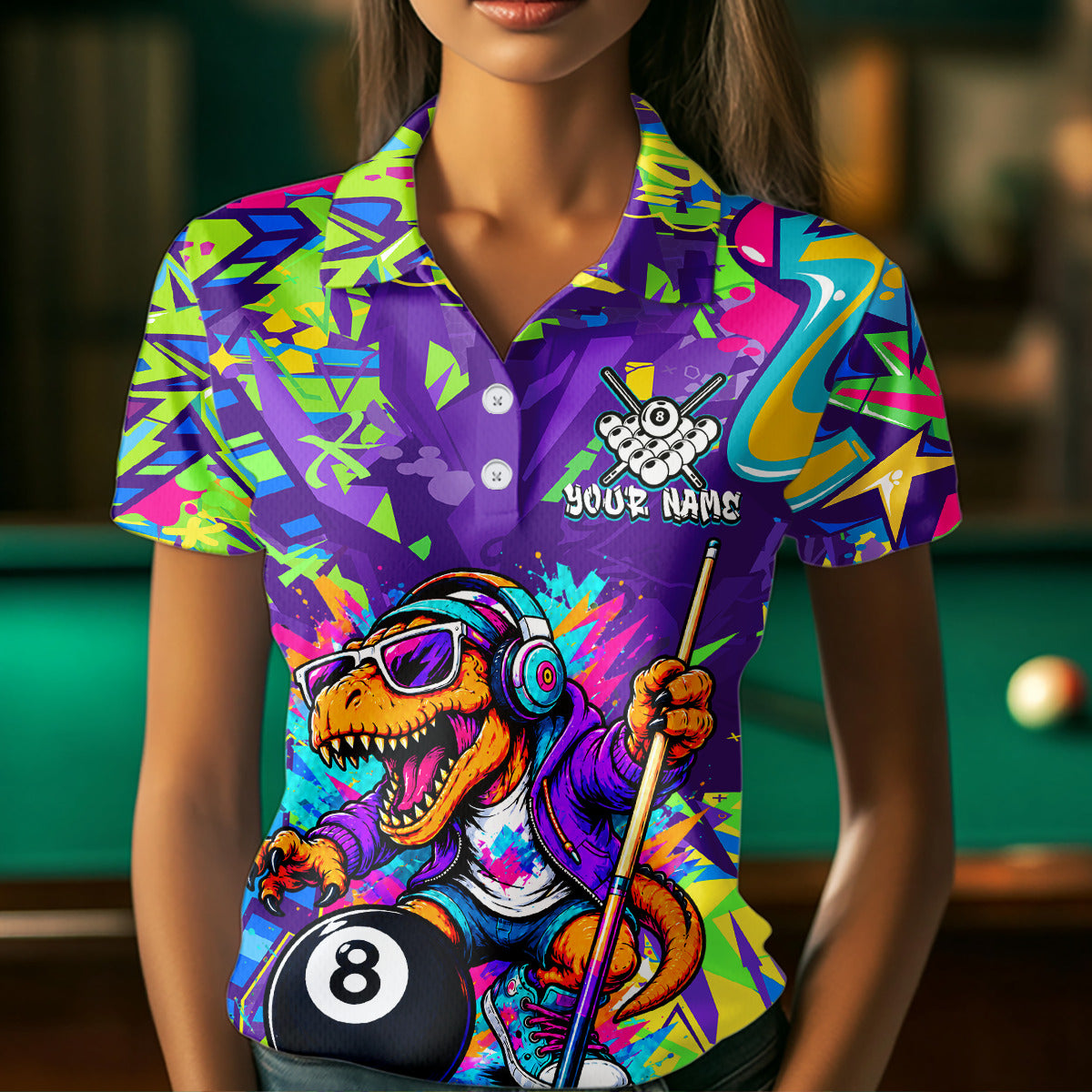 Person wearing a colorful polo shirt with a dinosaur holding a pool cue and billiard ball design.