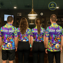 Load image into Gallery viewer, Four people wearing graffiti dinosaur shirts with a team name on the back in a bowling alley.