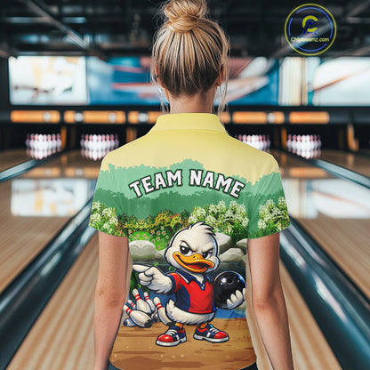 Person wearing a bowling-themed shirt with a cartoon duck character in a bowling alley.