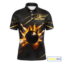 Load image into Gallery viewer, Front view custom black gold bowling polo shirt featuring a fiery bowling ball, flame burst effect and gold stripe pattern, displaying Your Name 