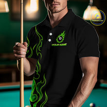 Load image into Gallery viewer, Men wearing billiards polo shirt featuring an eight ball design surrounded by flowing green flame graphics on a black background.