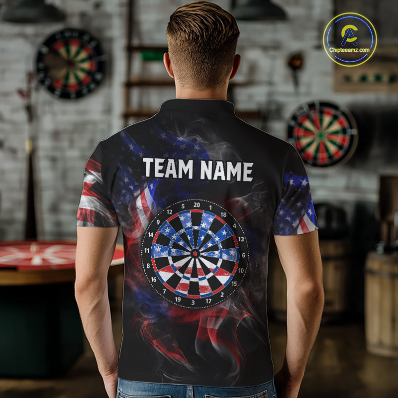 Man wearing a black darts polo featuring patriotic American flag smoke graphics, dartboards, blue darts, and custom team and player name text.