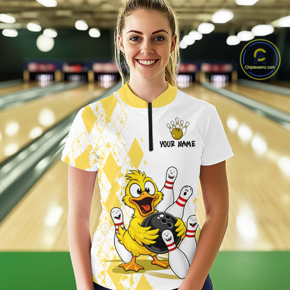 A woman stands in a bowling alley wearing a white and yellow bowling-themed custom jersey with a cartoon duck holding a bowling ball and the text 'YOUR NAME' on the chest. A circular 'Chilewich.