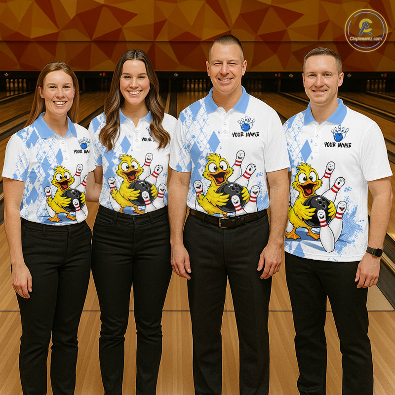 Four people standing together in a bowling alley wearing matching white and light blue bowling shirts with a cartoon bird character, black pants, and bowling pins and lanes in the background.