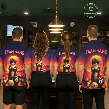 Four people standing with their backs to the camera in a dimly lit indoor environment, wearing matching custom-designed polo shirts. The shirts feature a dark blue base with a vibrant orange and yellow gradient, a graphic of a black cat wearing sunglasses and a yellow hat, billiard balls, and the text 'TEAM NAME'.