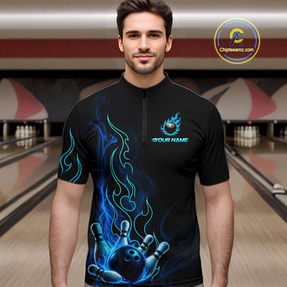 A man wearing a black short-sleeve quarter-zip bowling-themed t-shirt with blue flame graphics and a bowling ball graphic on the chest, set against a bowling alley background.