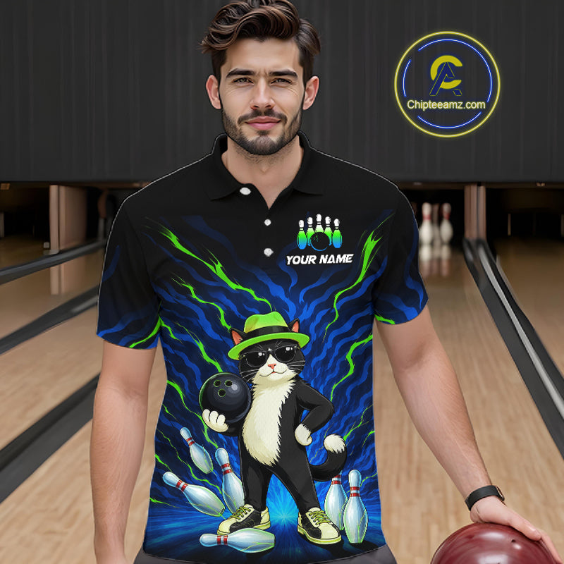 A man wearing a black short-sleeve polo shirt with a colorful bowling-themed cat graphic, standing in a bowling alley. The shirt features a cartoon cat in a green hat and sunglasses holding a bowling ball, with bowling pins and blue lightning effects.