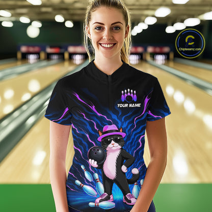 A woman stands in a bowling alley wearing a black short-sleeve bowling shirt with a colorful graphic of a cat bowling and the text 'YOUR NAME' under a bowling pins icon. A circular 'Chilewich.