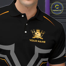 Load image into Gallery viewer, Black polo shirt with gold logo and text on a dark background