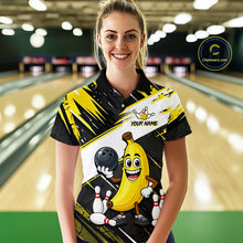 Load image into Gallery viewer, Women wearing a bowling-themed shirt with a cartoon banana character in a bowling alley.