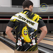Load image into Gallery viewer, Man wearing a bowling-themed shirt with a cartoon banana character in a bowling alley.