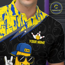 Load image into Gallery viewer, Man wearing a black shirt with a yellow and blue design, featuring a cartoon character and text.