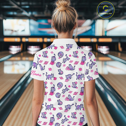 Woman wearing a white shirt with pink cat pattern in a bowling alley.