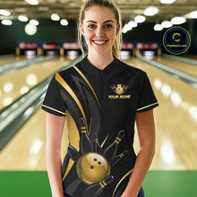 Load image into Gallery viewer, Woman wearing a black and gold bowling shirt with a logo and text in a bowling alley.