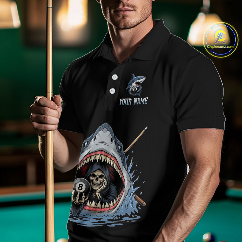Person wearing a black polo shirt with a shark and skull design, holding a pool cue in a billiards setting.