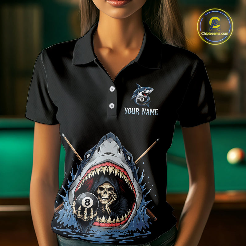 Black polo shirt with a shark and skull design in front of a pool table.