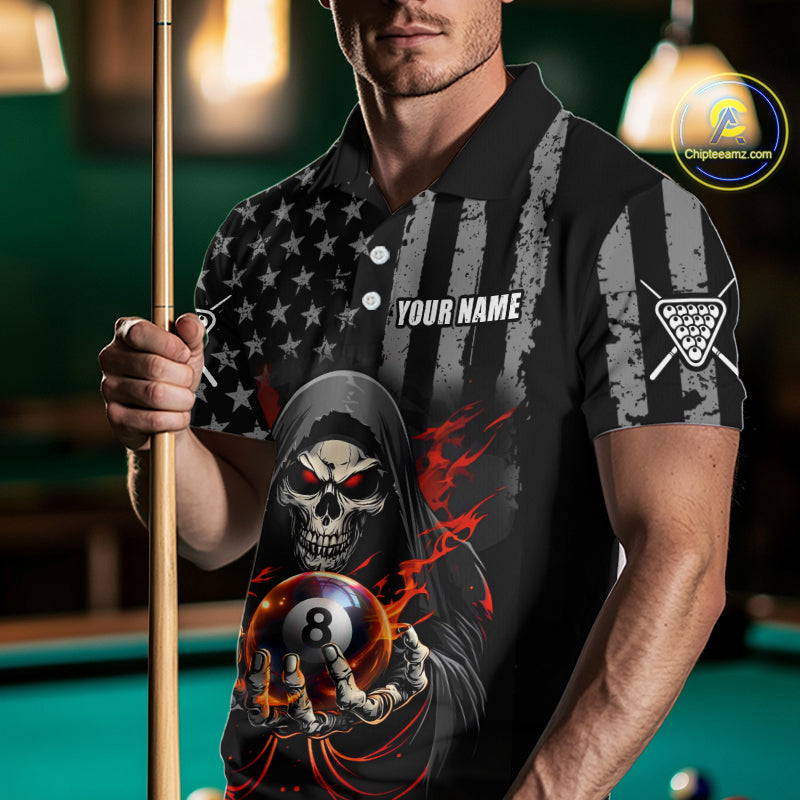 Man wearing a black and gray polo shirt with a skull design holding a pool cue on a pool table.