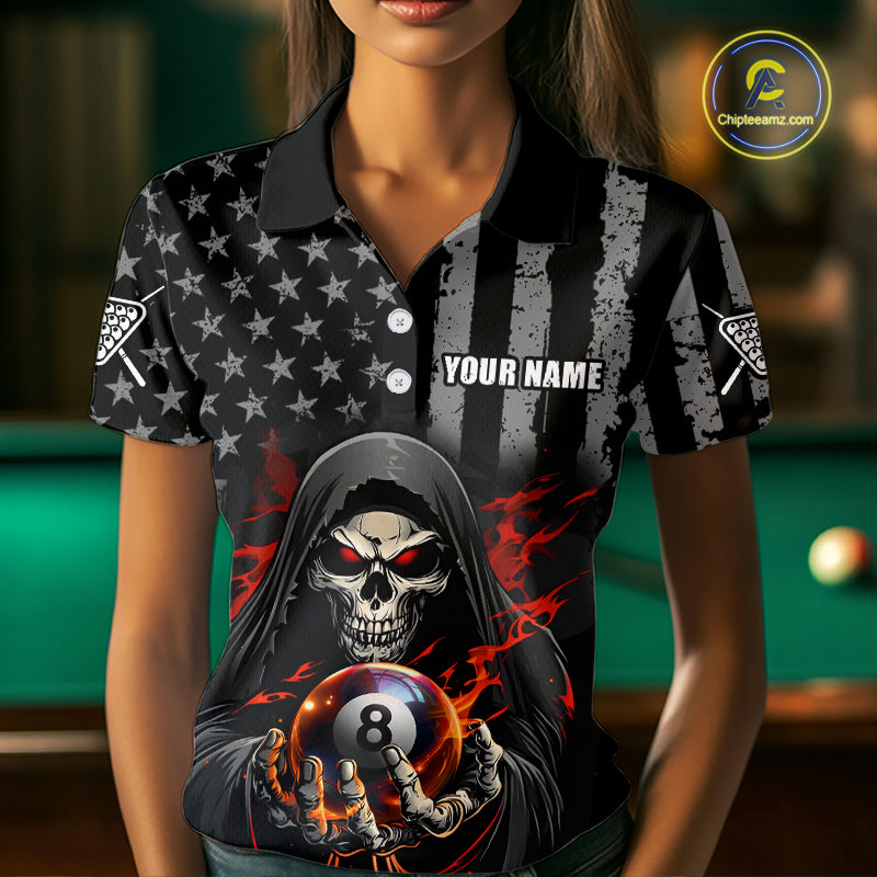 Woman wearing a black and gray striped shirt with a skull and 8-ball design, standing in front of a pool table.