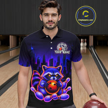Load image into Gallery viewer, Man wearing bowling polo shirt featuring a raccoon holding a bowling ball framed by pins with purple city skyline background.