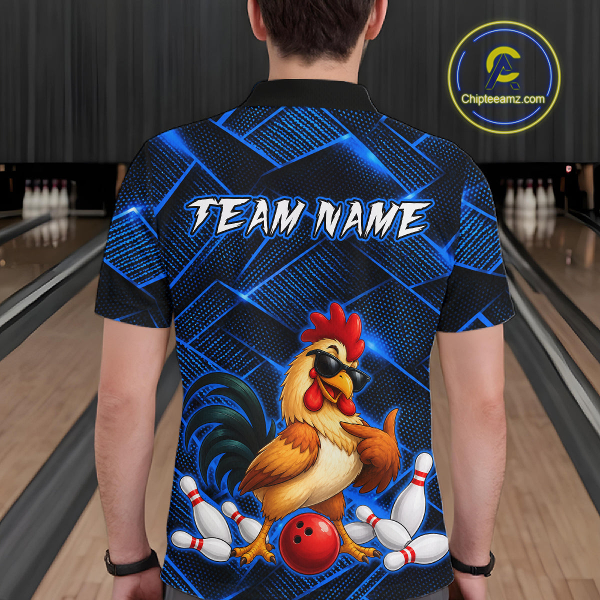 Man wearing a blue and black bowling polo shirt featuring a cool rooster mascot wearing sunglasses, a red bowling ball, bowling pins, and custom team name text.
