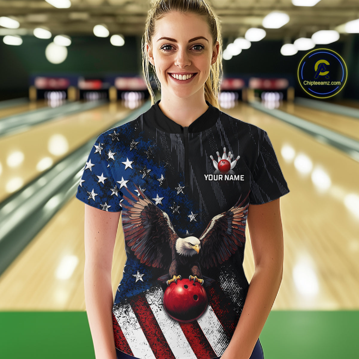 A woman stands in a bowling alley wearing a custom bowling jersey with a patriotic American flag design, featuring an eagle holding a red bowling ball. The jersey has a black collar and the text 'YOUR NAME' and 'Chipsworld.