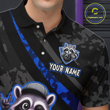 Load image into Gallery viewer, Black and blue polo shirt with raccoon graphics and customizable text on a dark background