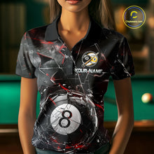 Load image into Gallery viewer, Woman wearing a black collared polo shirt with shattered glass graphics, red accent streaks, a custom name area, and a large cracked 8-ball illustration across the lower front.